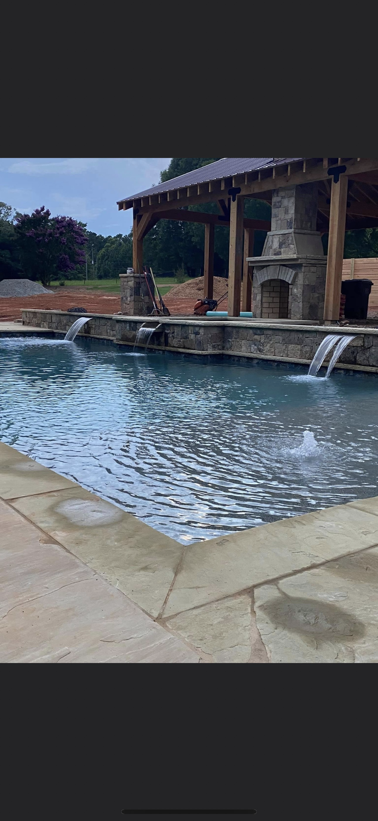 Infinity pool at dusk with outdoor living area