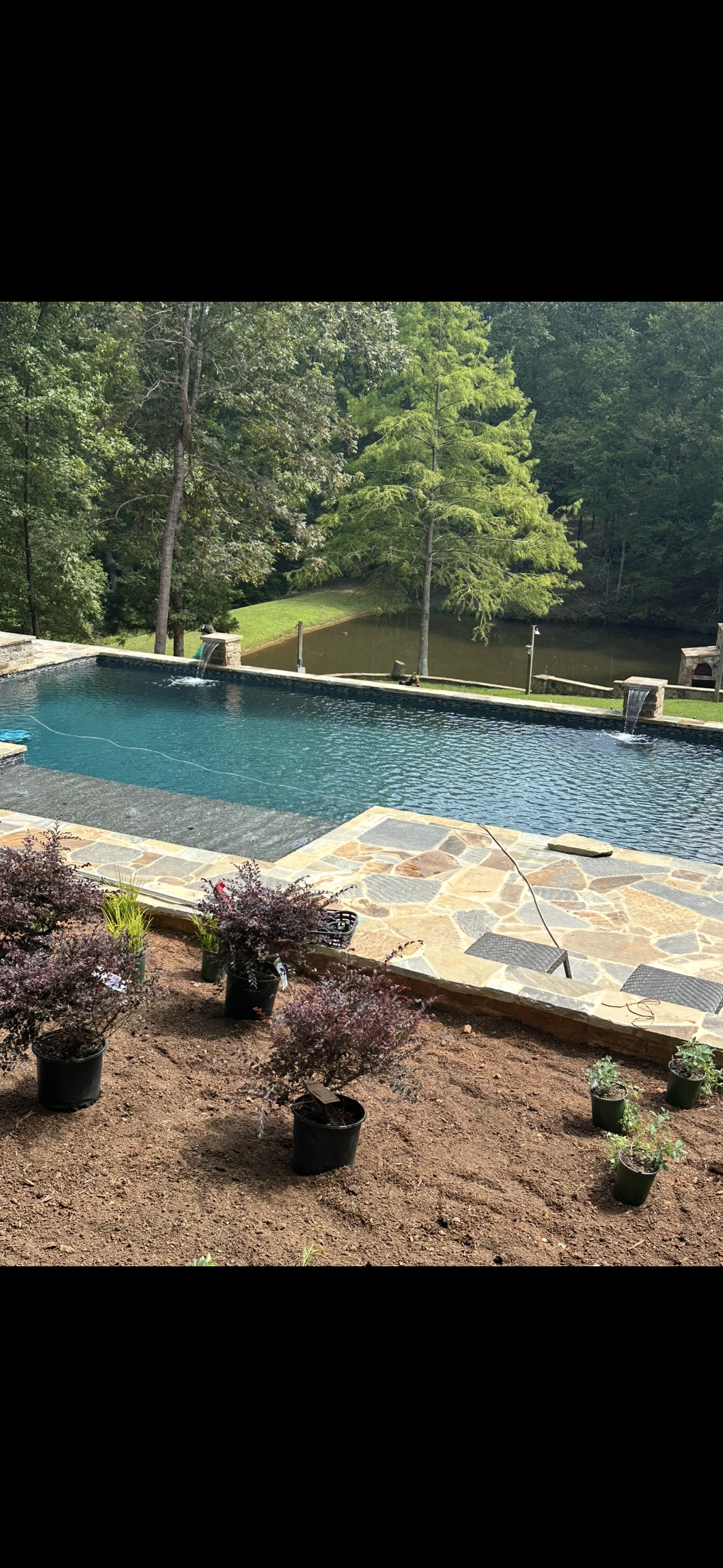 Pool with waterfall feature and spa