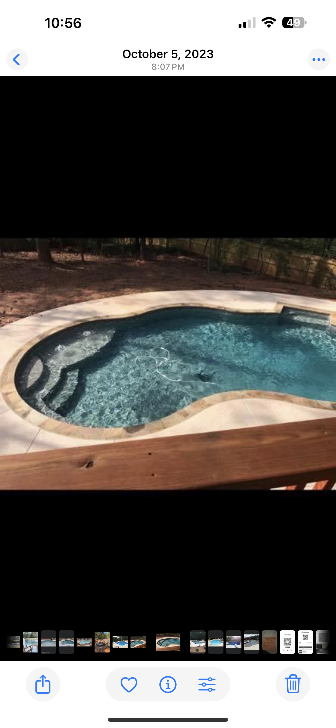 Freeform vinyl liner pool at night with underwater lighting